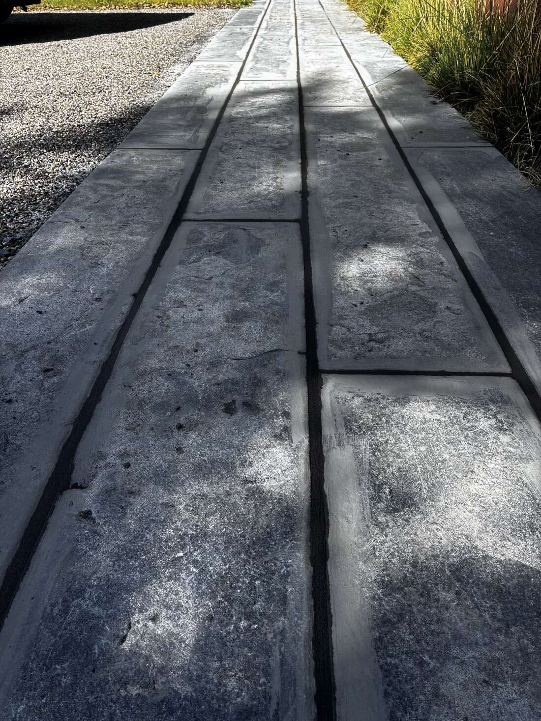 Long bluestone plank walkway with even joint lines