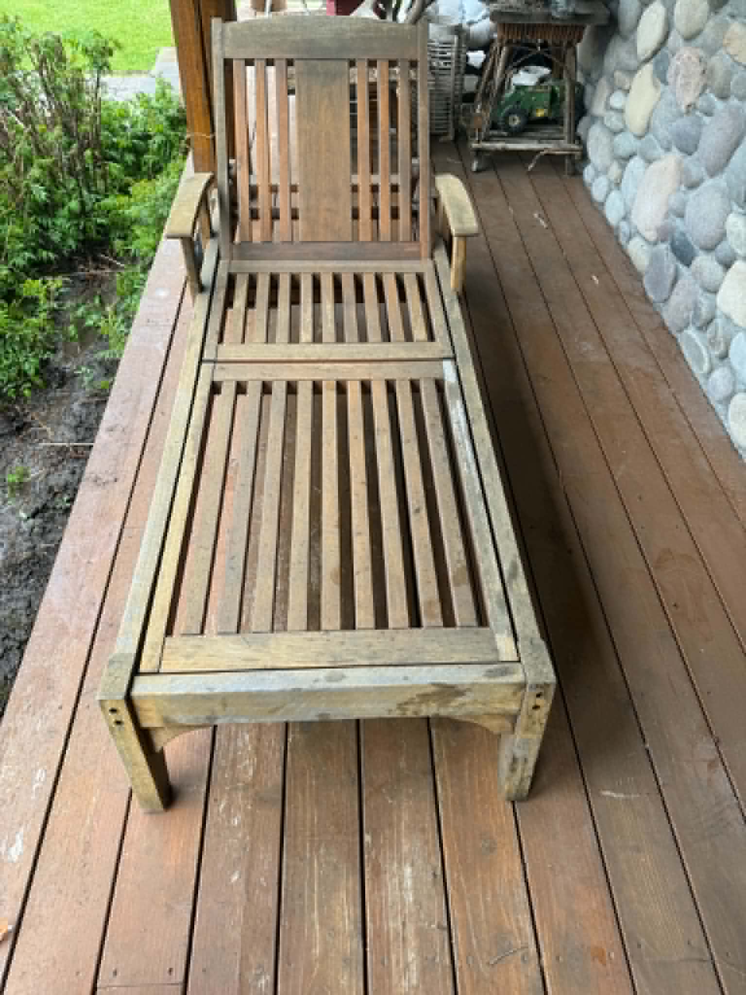 Weathered teak chaise lounger before refinishing